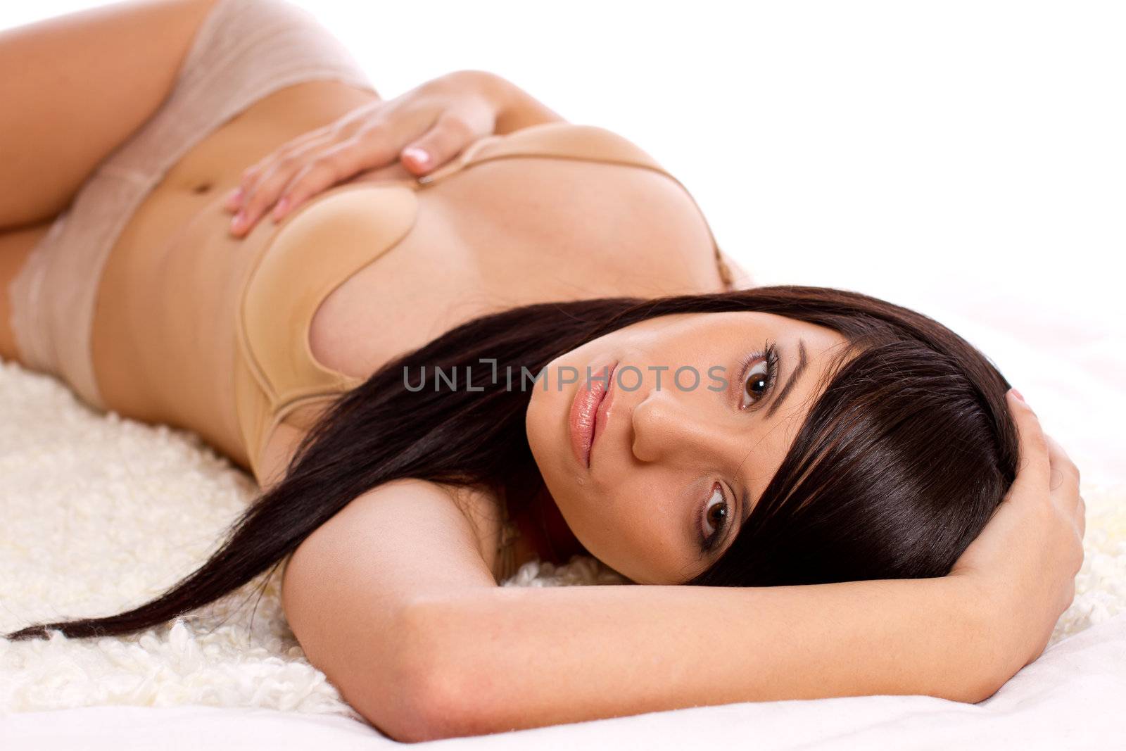 Beautiful fasion model in lingerie lying in bed