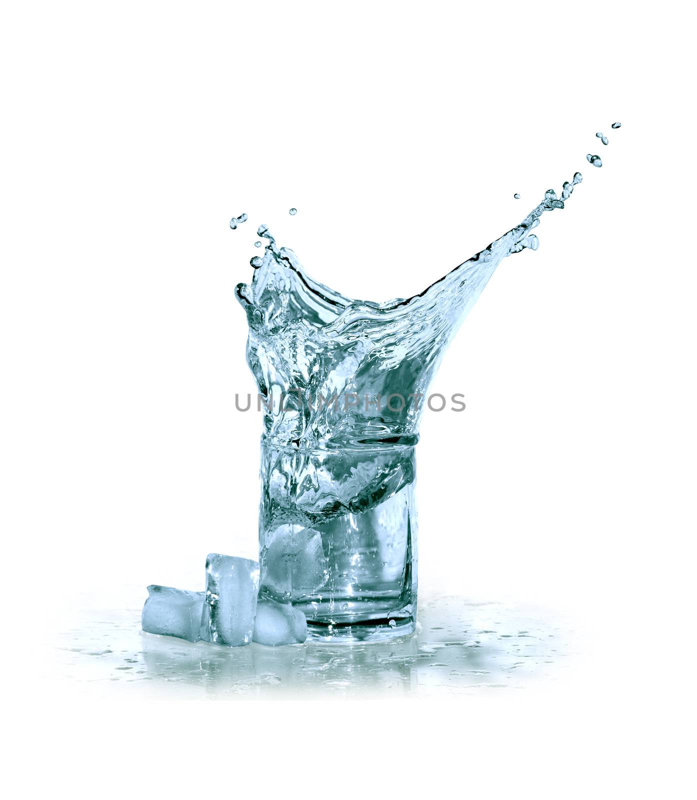 Glass of splashing water near ice cubes on white background. Clipping path is included