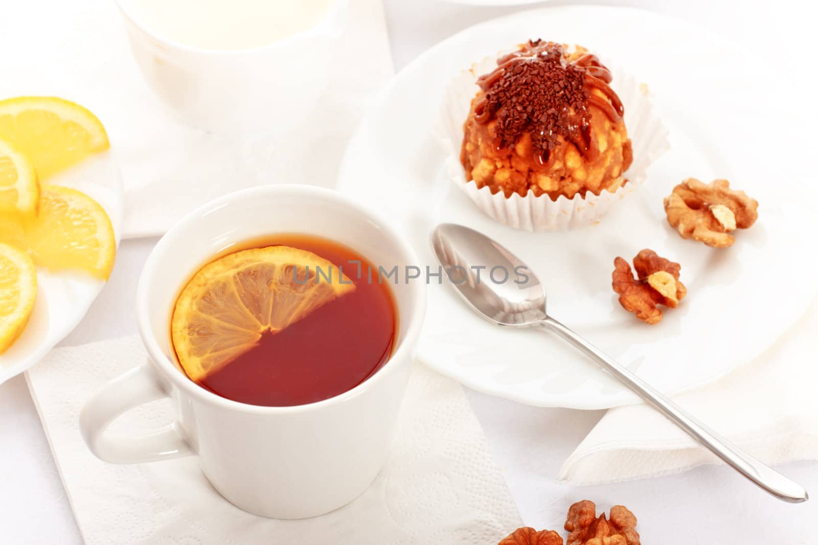 tea with lemon and fancy cakes, still life