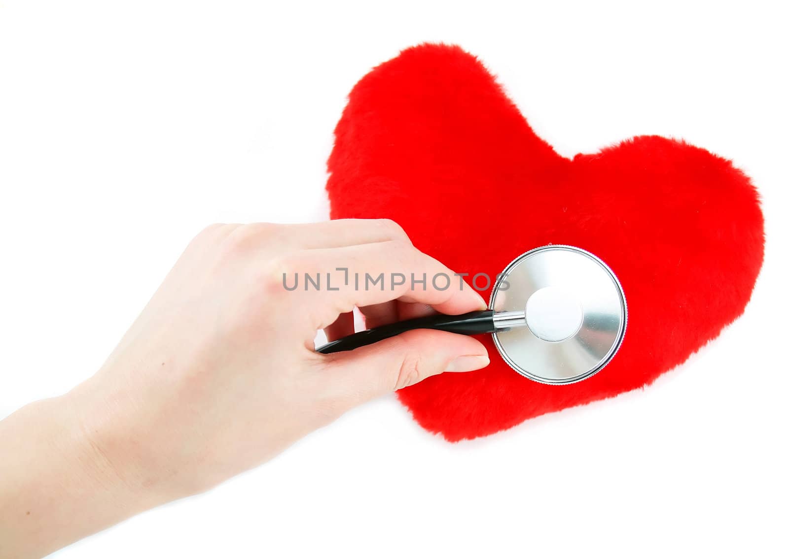 Hand with stethoscope checking a red heart isolated by alphacell