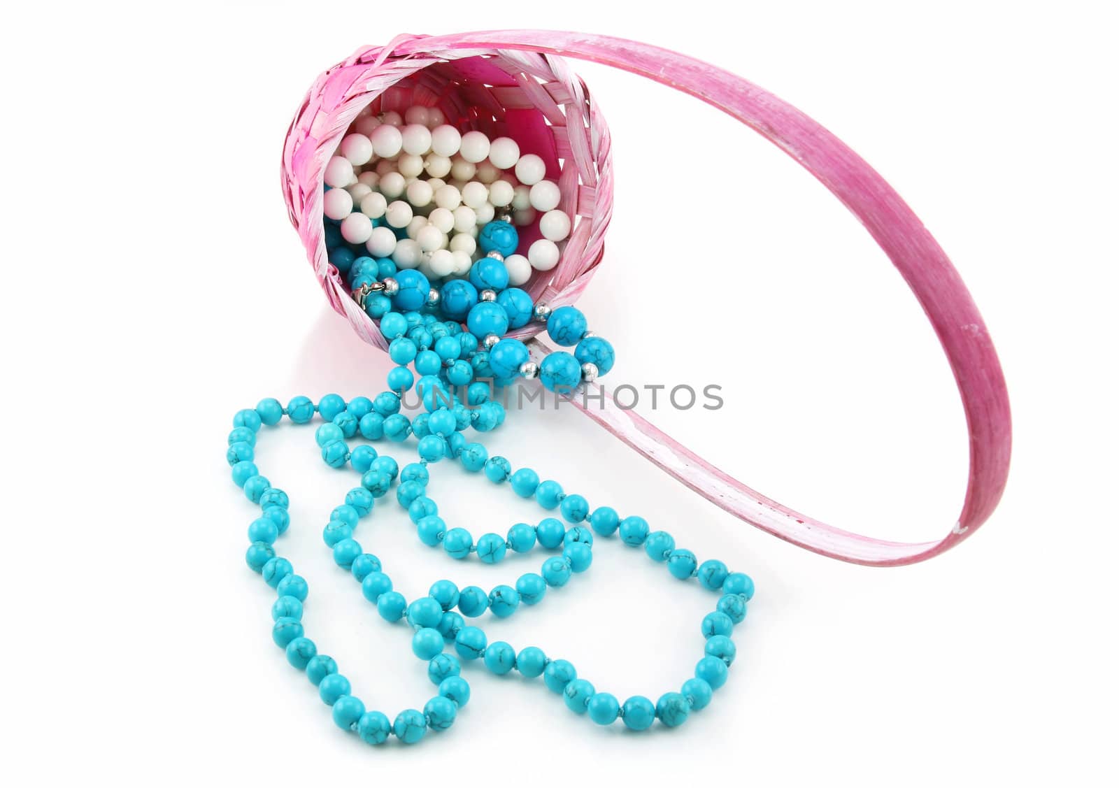 Colored Pearl Beads in Pink Wicker Basket Isolated by alphacell