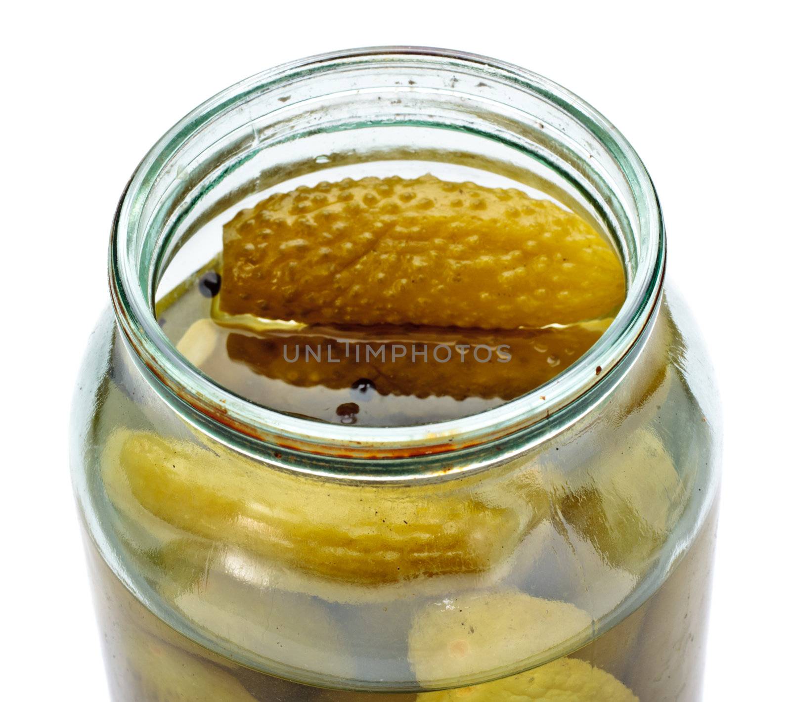 opened glass jar of green pickled cucumbers