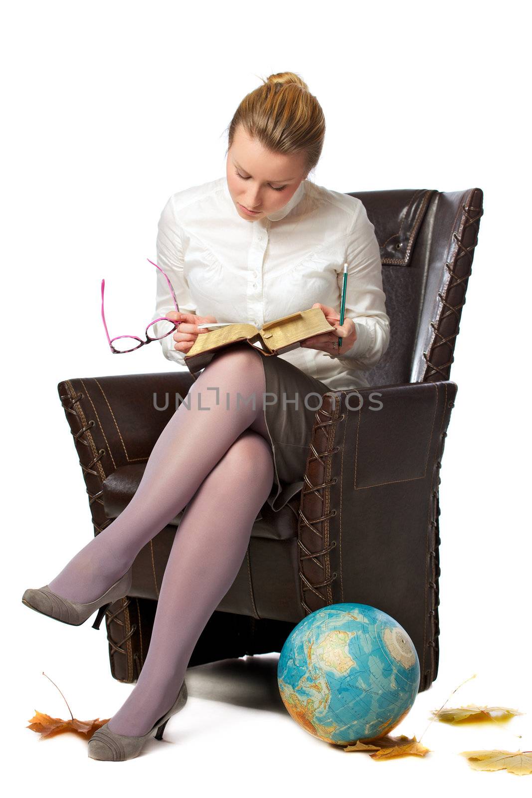 pretty female teacher sitting in armchair, isolated on white