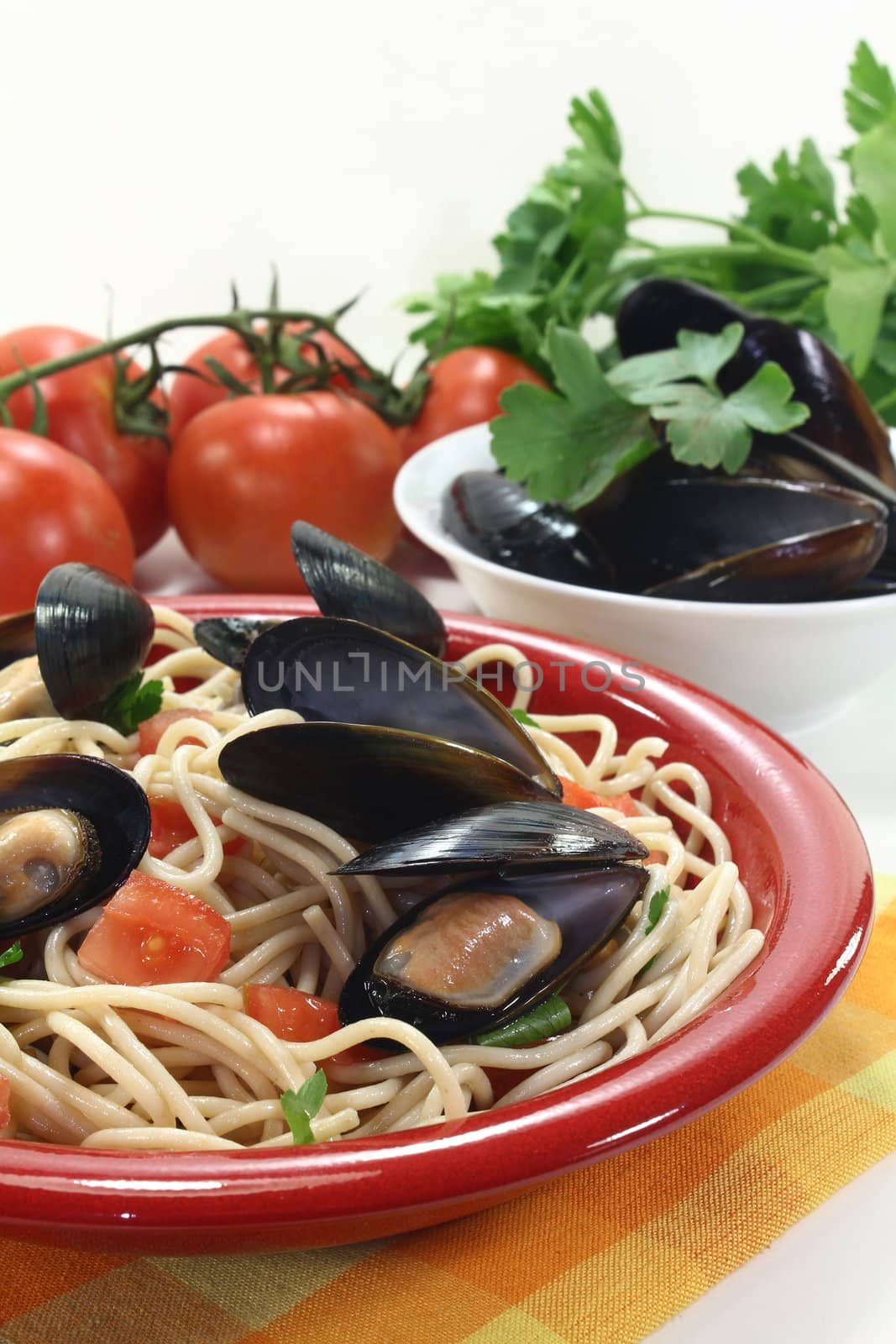 a plate of spaghetti, mussels and tomato