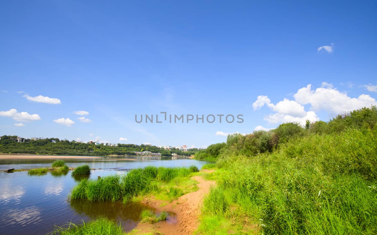 calm river under blue sky at summer day