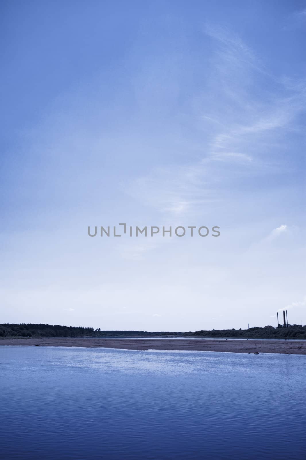 calm river under blue sky at summer day