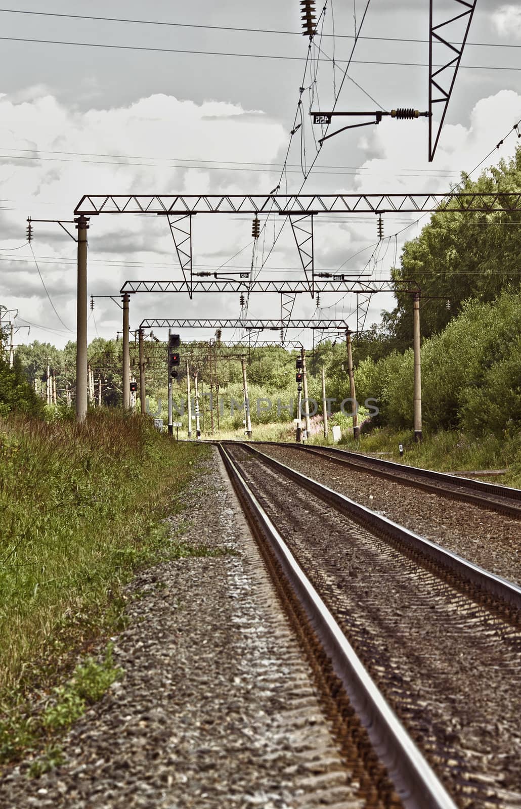 empty railroad track at cloudy summer day