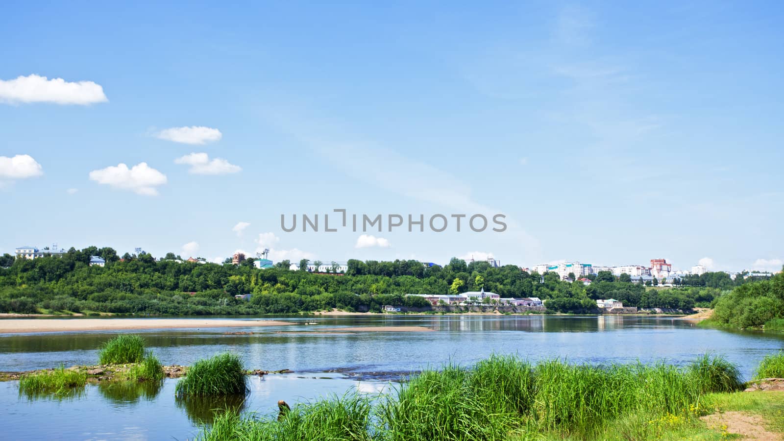 calm river under blue sky at summer day