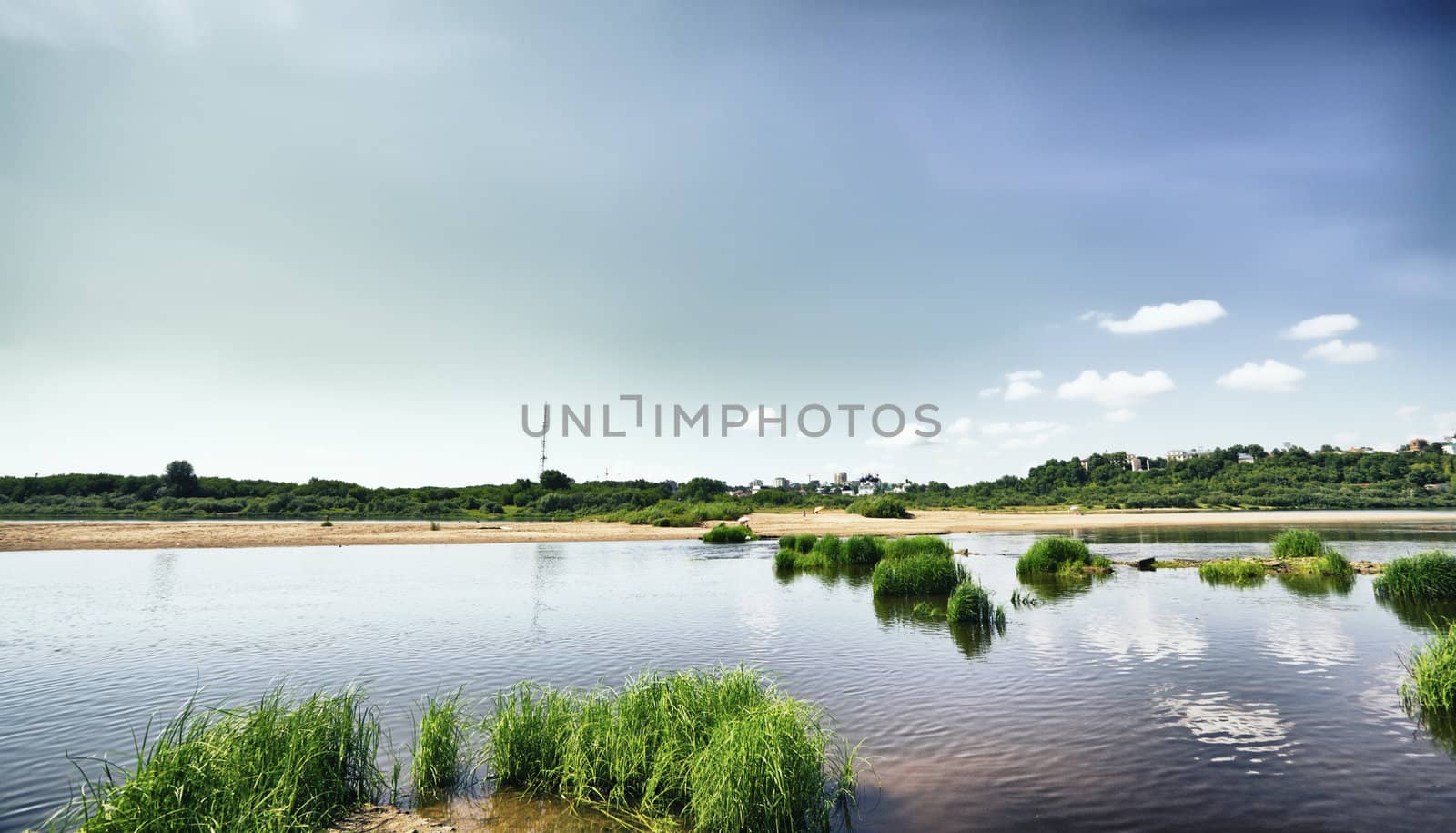 calm river under blue sky at summer day