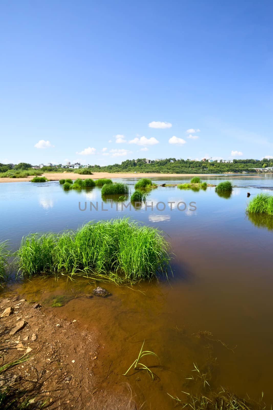 calm river under blue sky at summer day