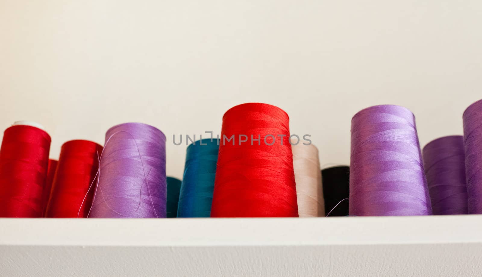 colorful reels of threads on a shelf