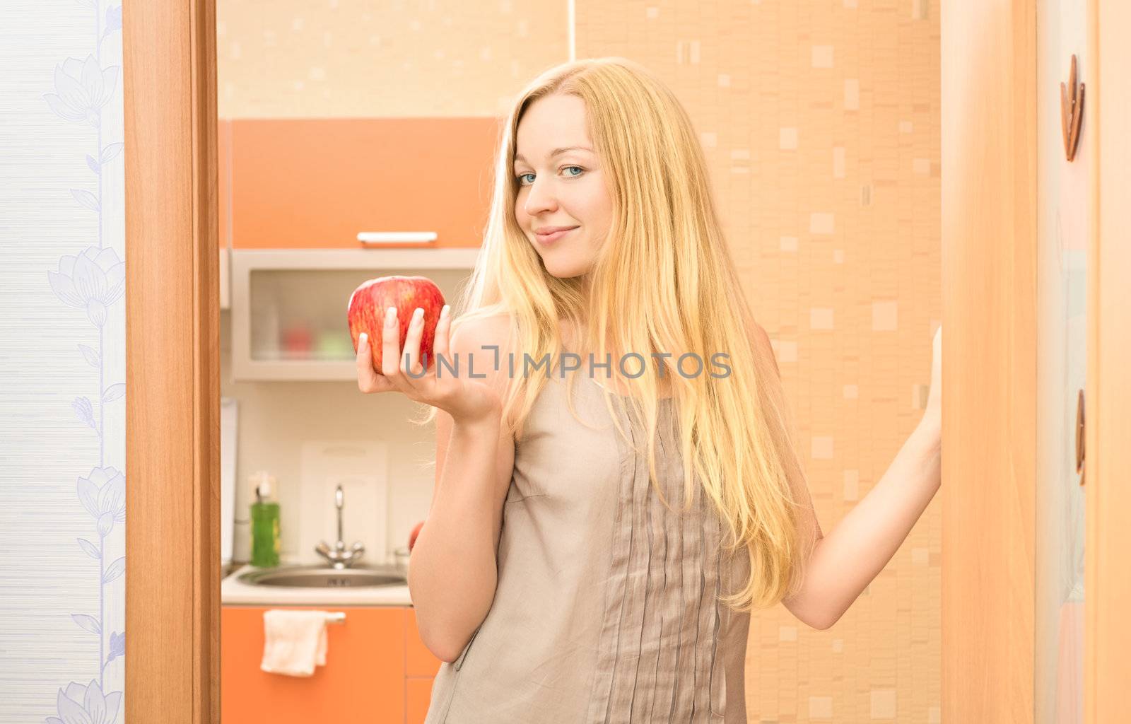 beautiful girl with fresh apple at home