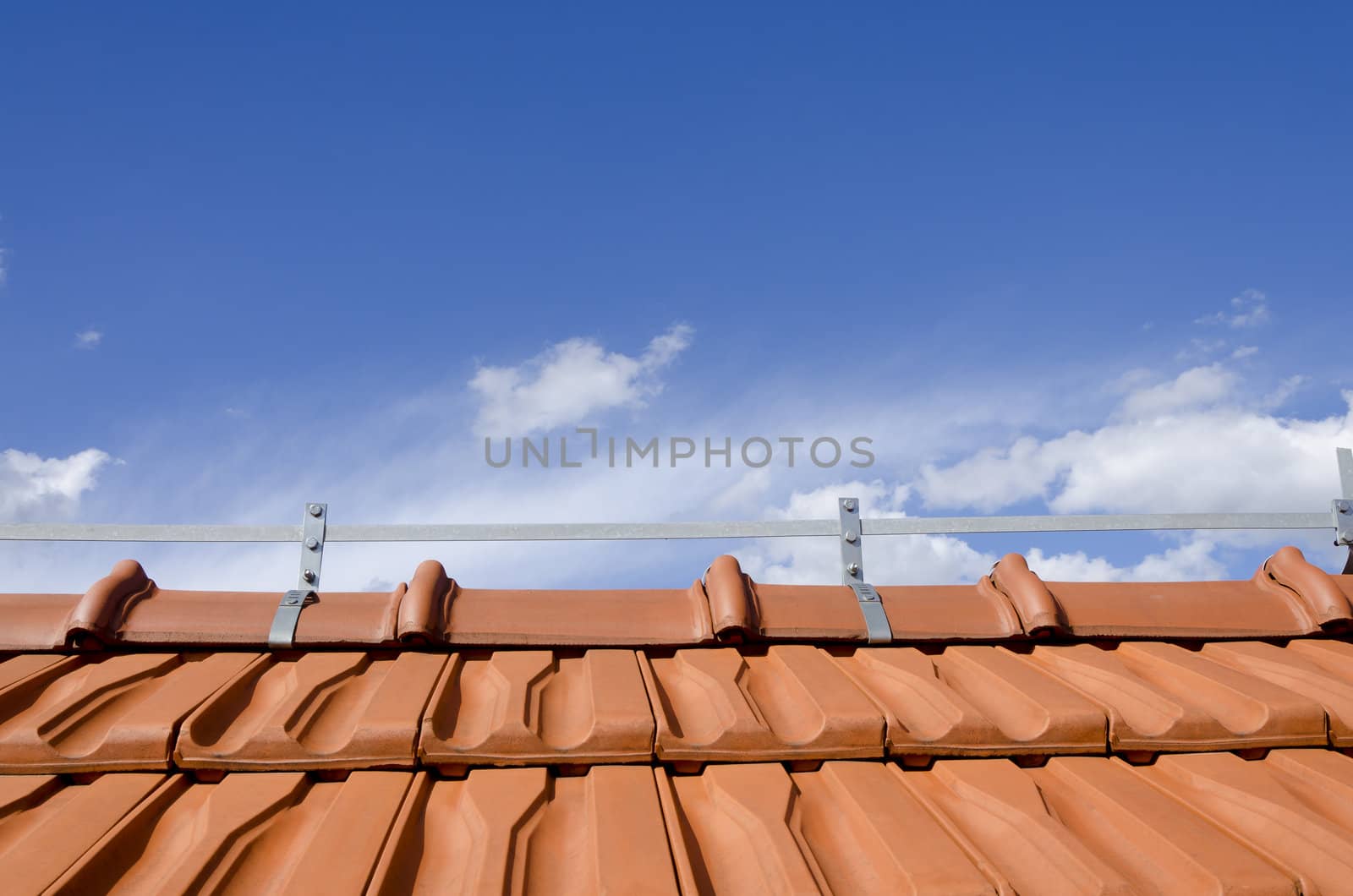 brick roof and blue sky with couple of white clouds