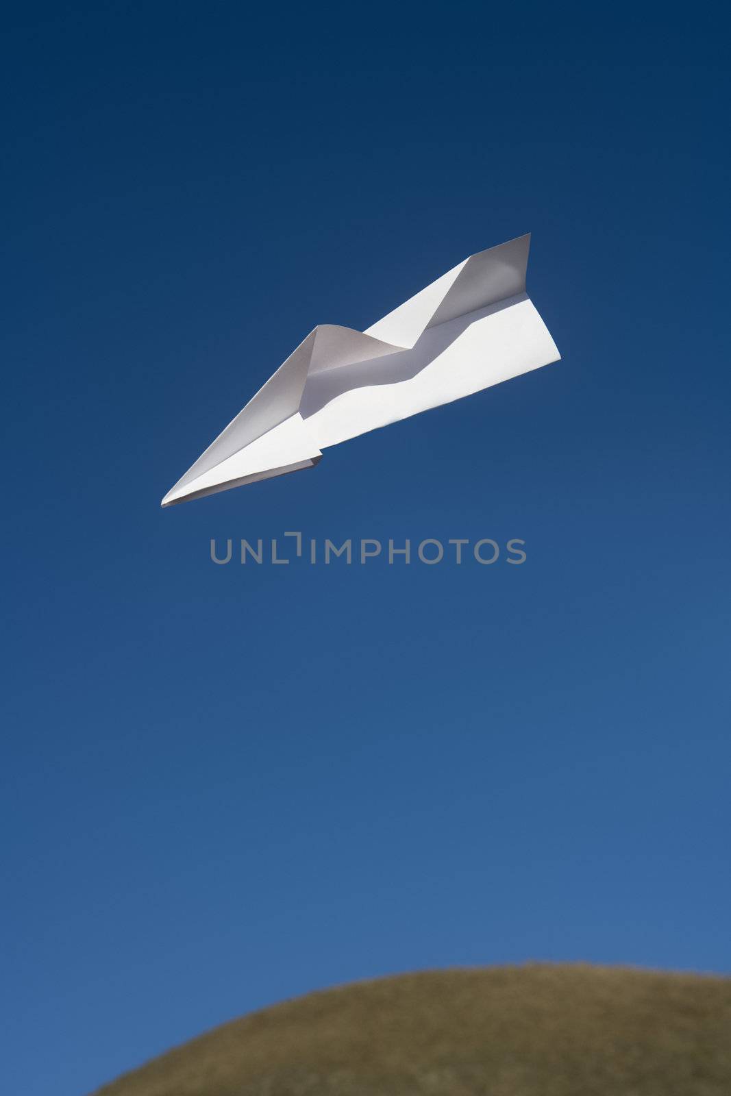 Paper Airplane flying towards blue sky