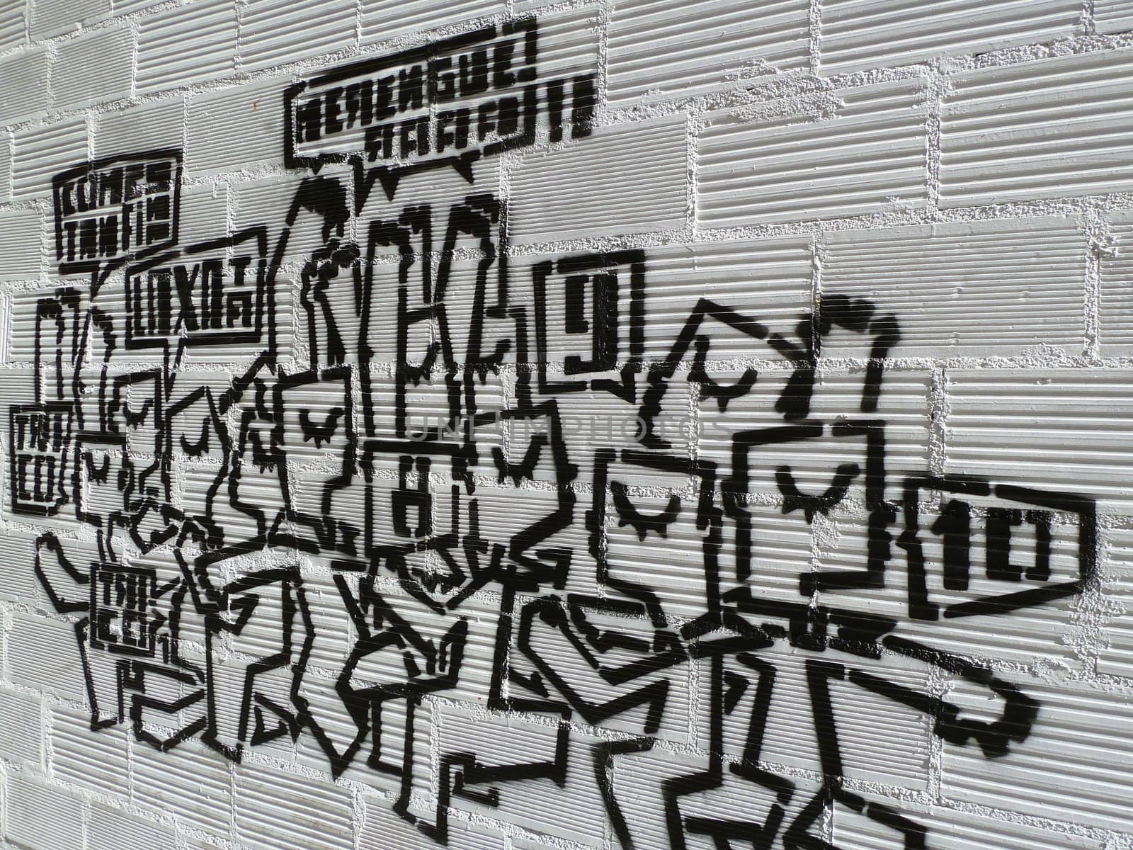 modern graffitti in black on a white wall