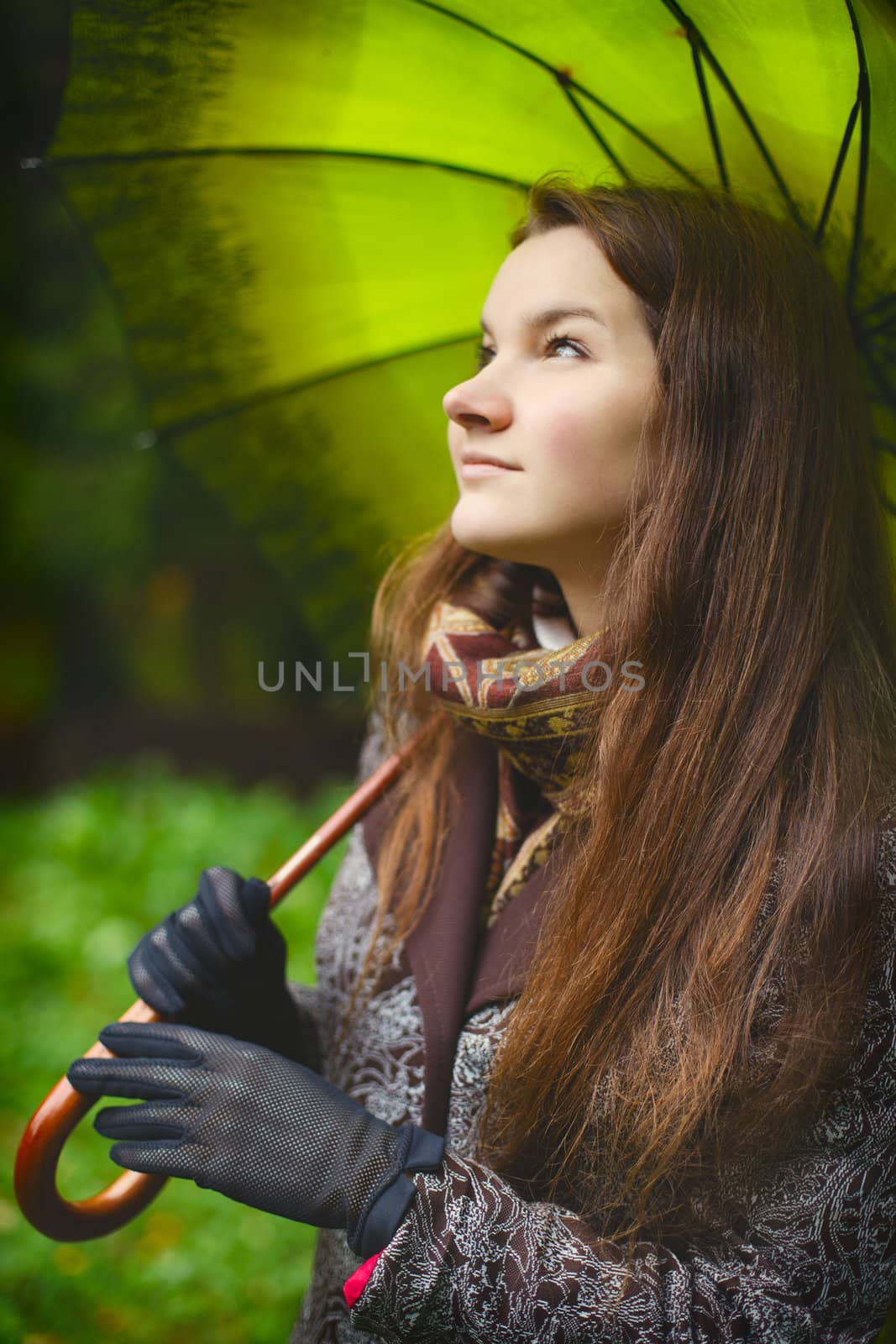 beautiful girl with long hair in autumn rainy forest