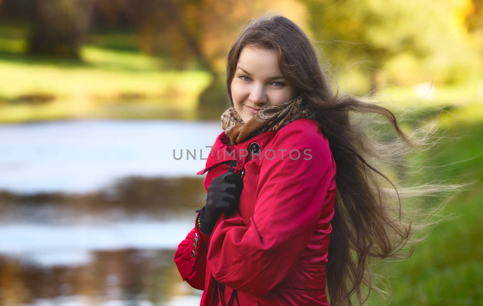 beautiful girl on river shore at autumn