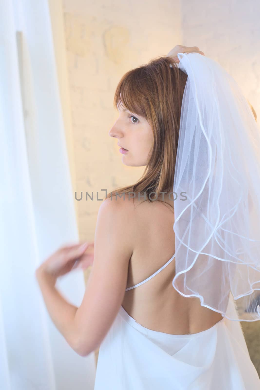 beautiful woman in white wedding dress and bridal veil