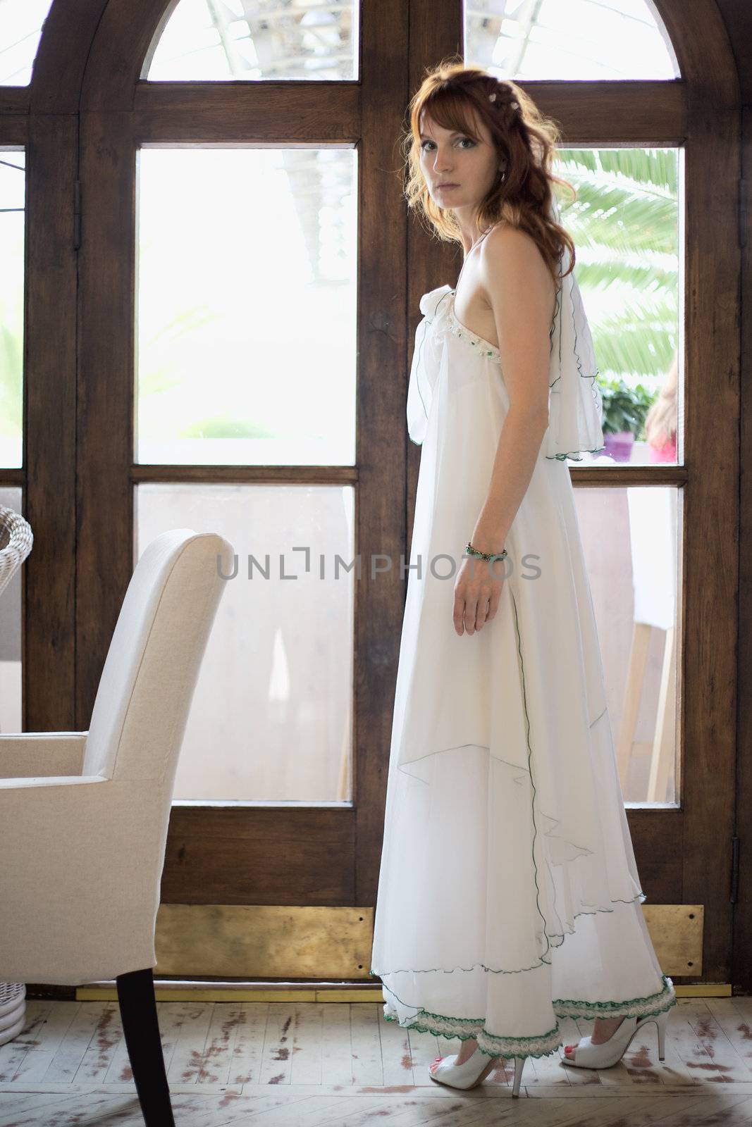beautiful woman in white wedding dress at interior