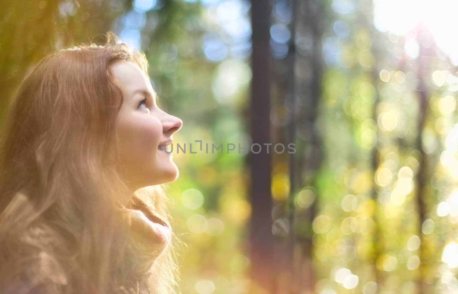 beautiful girl with long hair in enchanted autumn forest