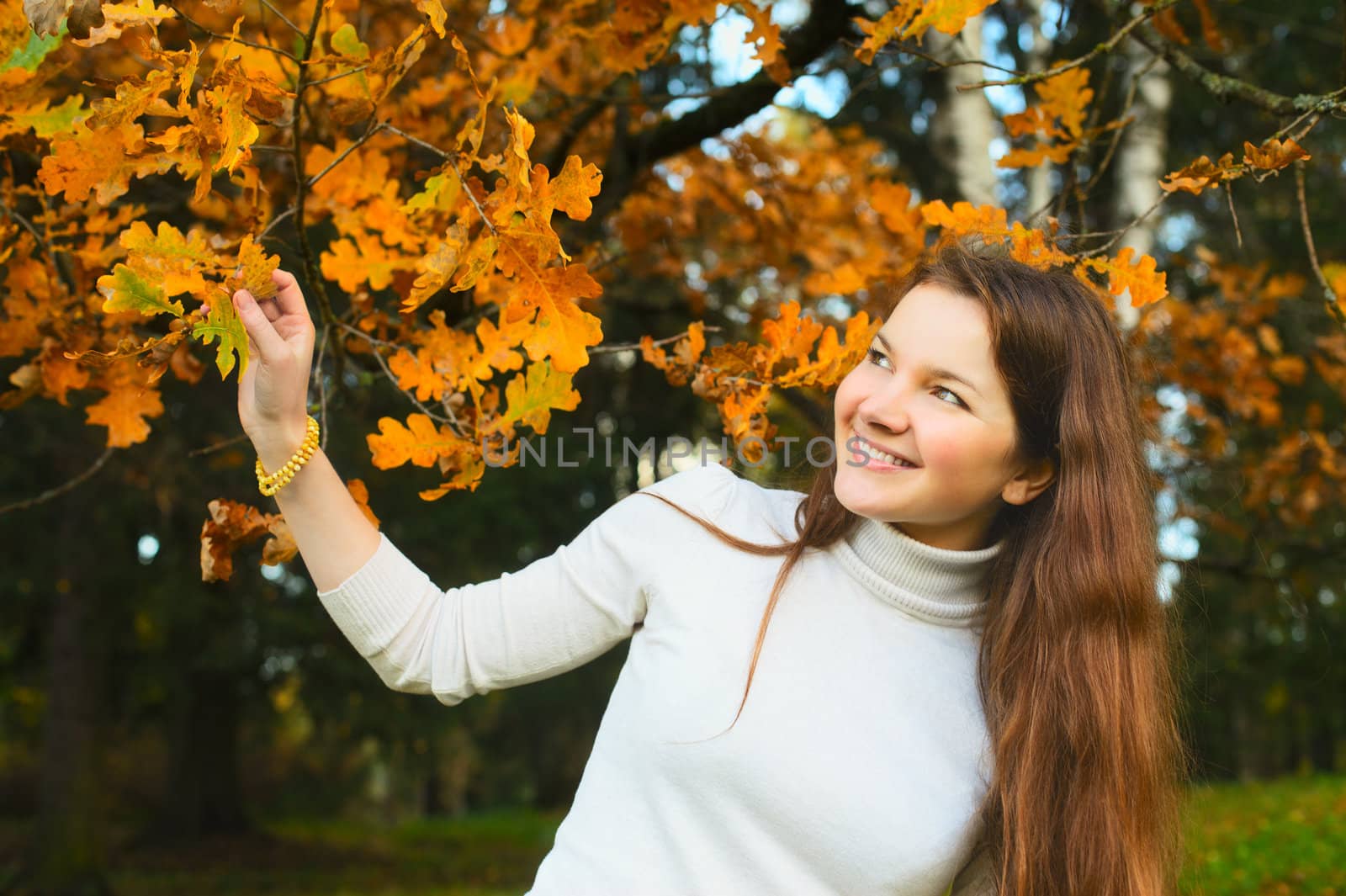 beautiful smiling girl in autumn oak forest