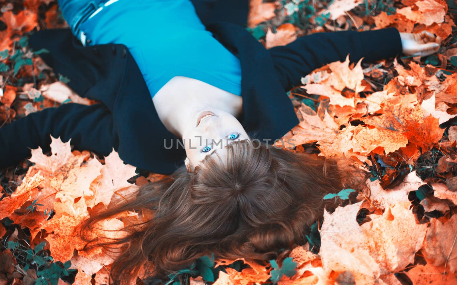 Girl Lying in Autumn Leaves by petr_malyshev