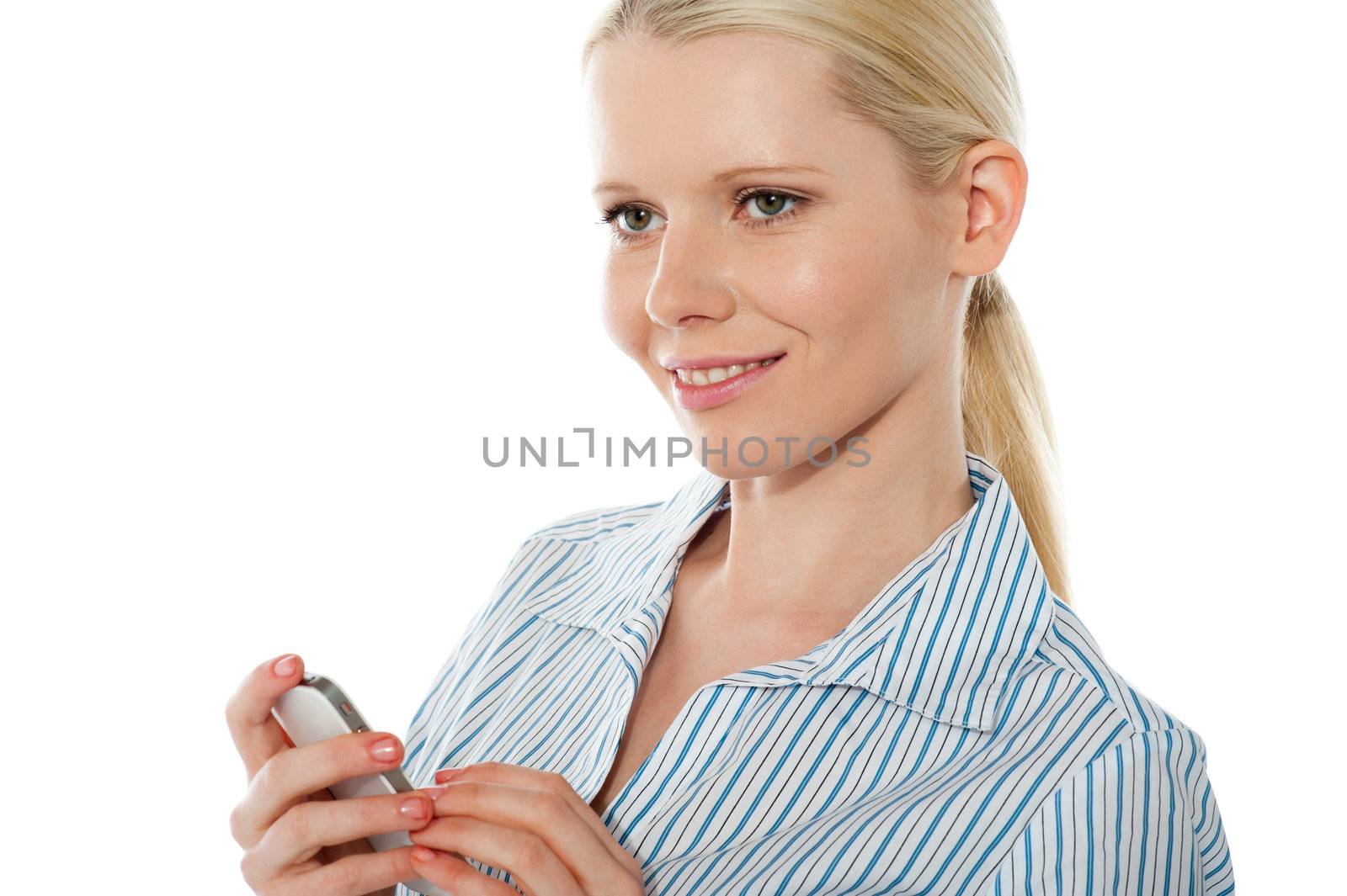 Beautiful corporate female using cellphone, smiling and looking away