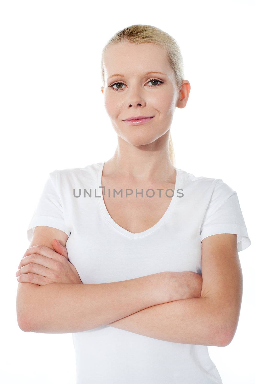 Smiling teenager with folded arms posing on white background