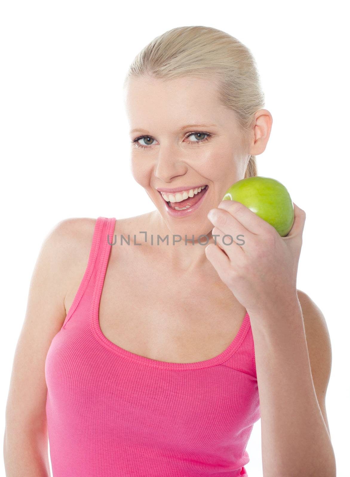 Pretty caucasian girl eating an apple by stockyimages