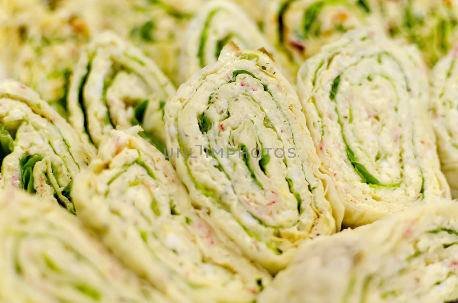 Pita bread. Rolls stuffed with greens and ham. Closeup.