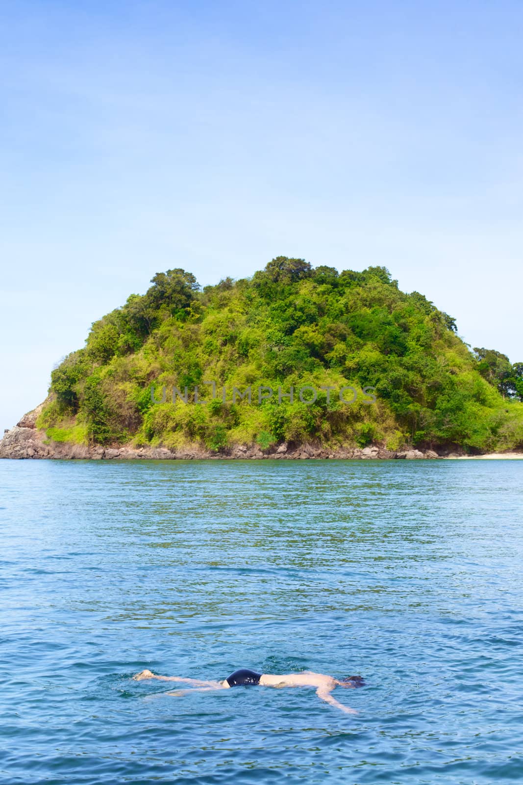 man snorkeling in Andaman Sea, Thailand, at sunny day