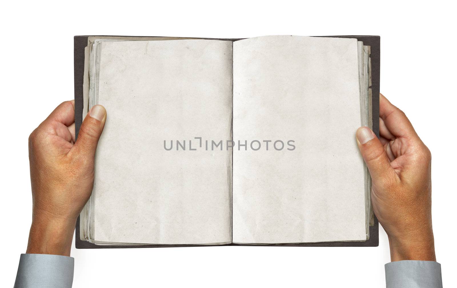 hands and opened vintage book over white background with path