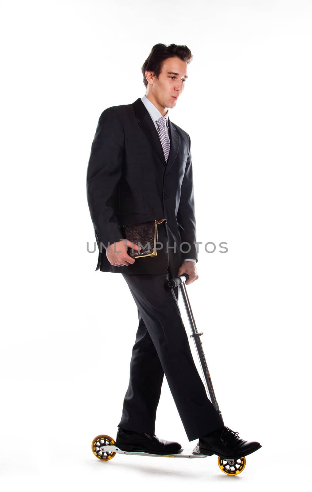 Portrait of a young respectable and successful man in a dark business suit who rides a scooter