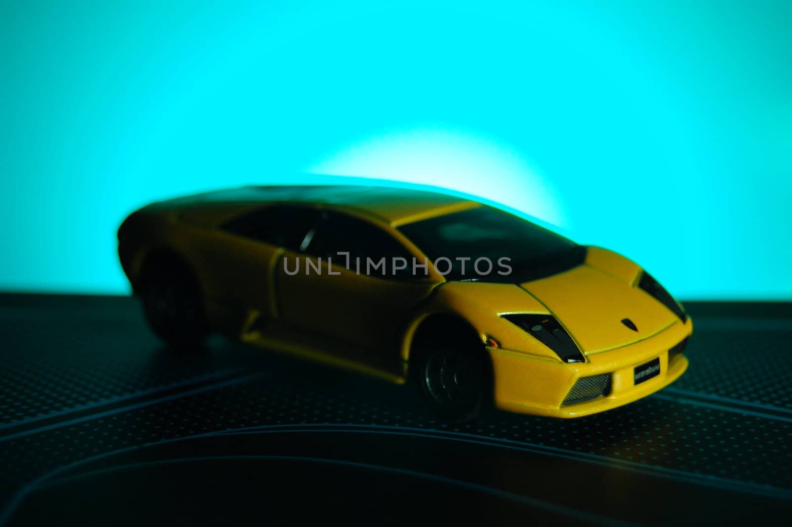 Scale model replica of lamborghini murciélago on blue sunburst background