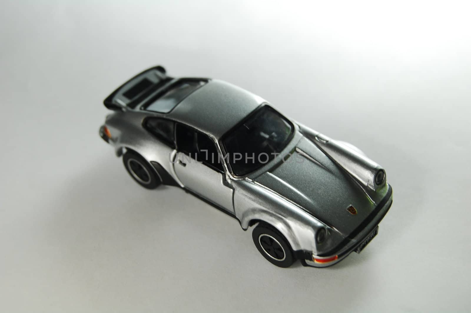 Scale model replica of porsche 911 turbo type 930 on white background