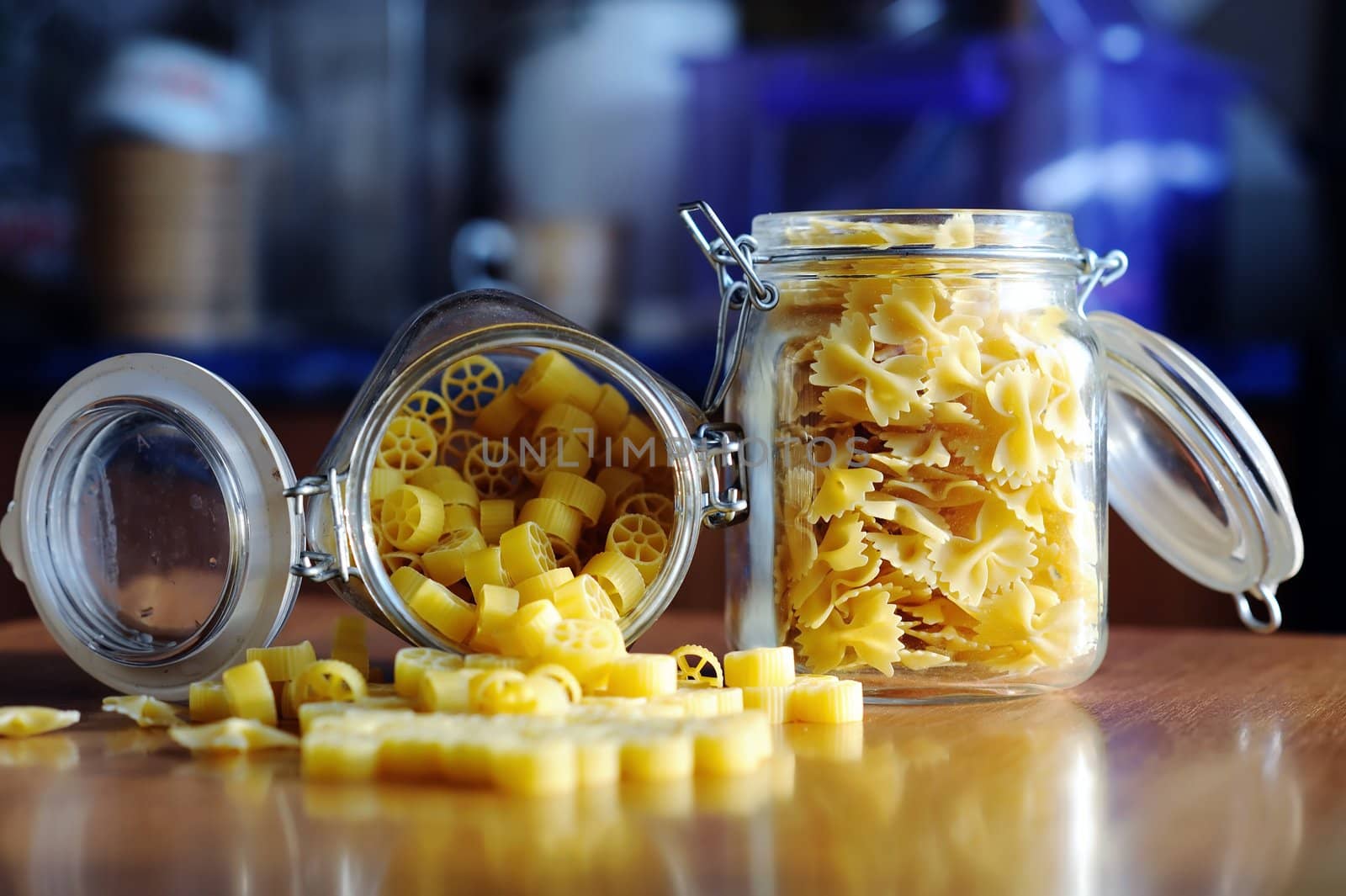 An image of yellow pasta in two jars