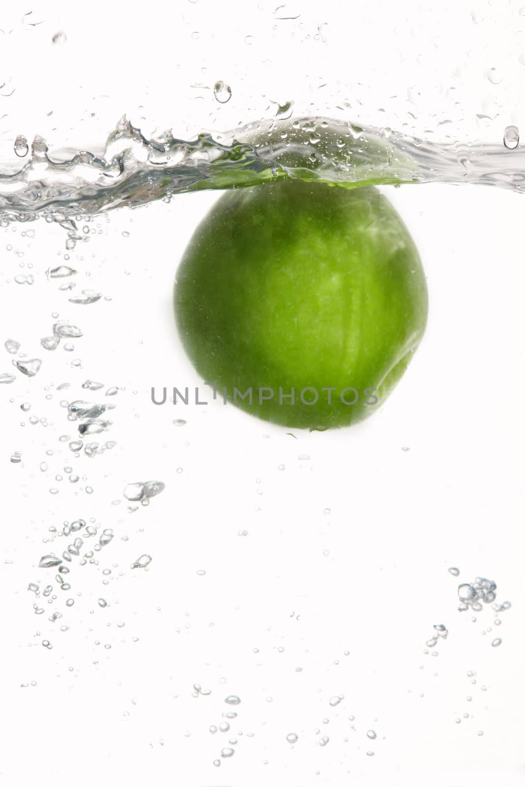 An image of fresh green apple in water
