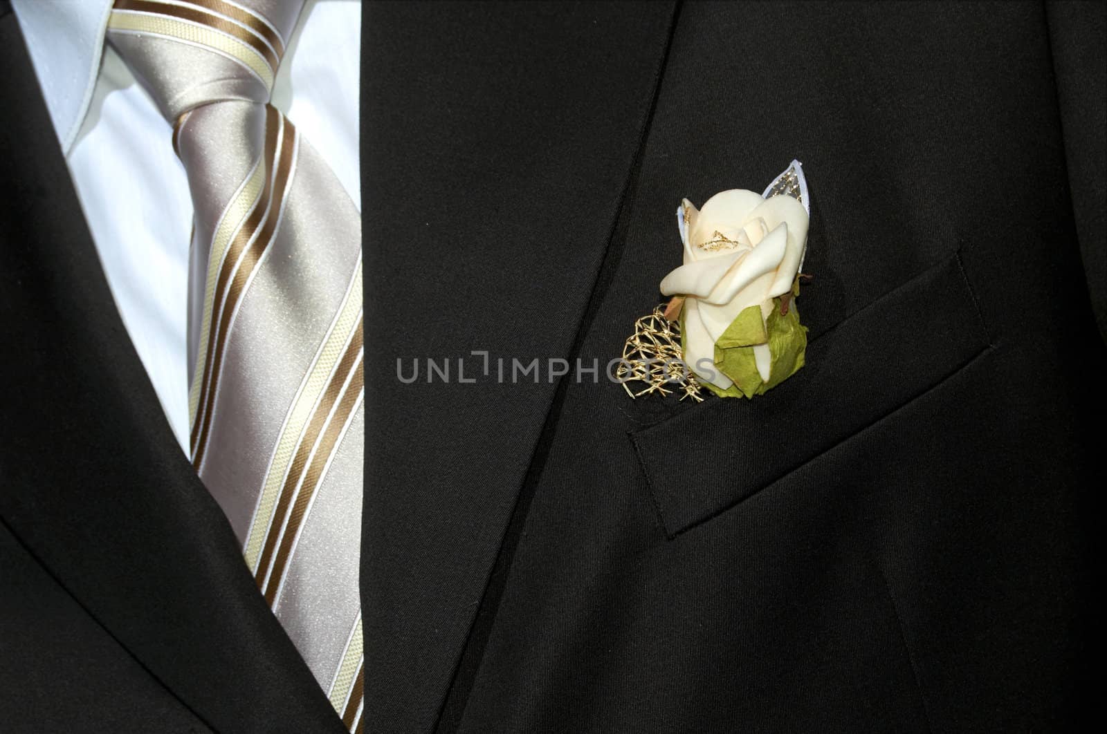 An image of black suit with flower