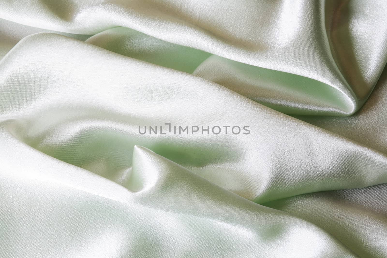 An image of folds of green shine cloth