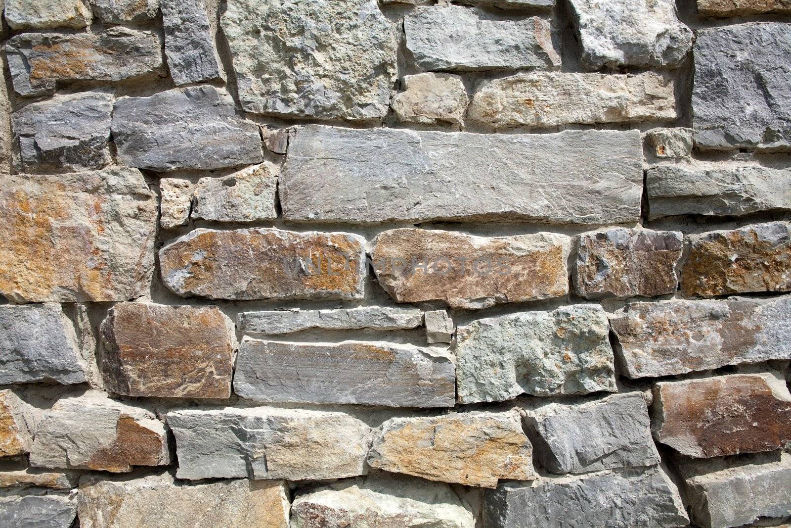 An image of a grey wall of stone