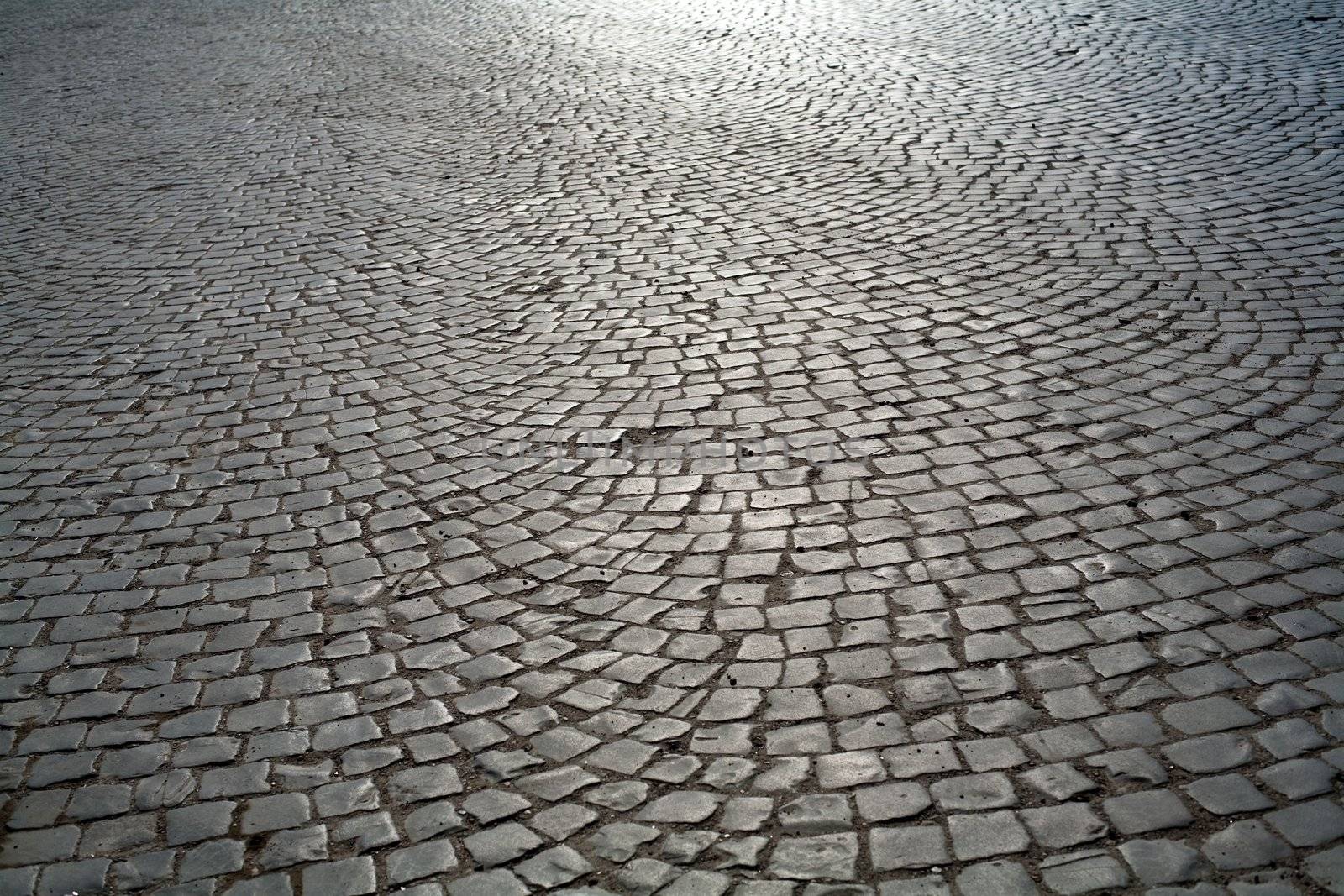 An image of a road of grey stones