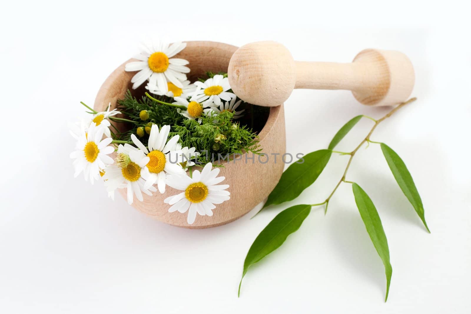 An image of white flowers in a wooden mortar