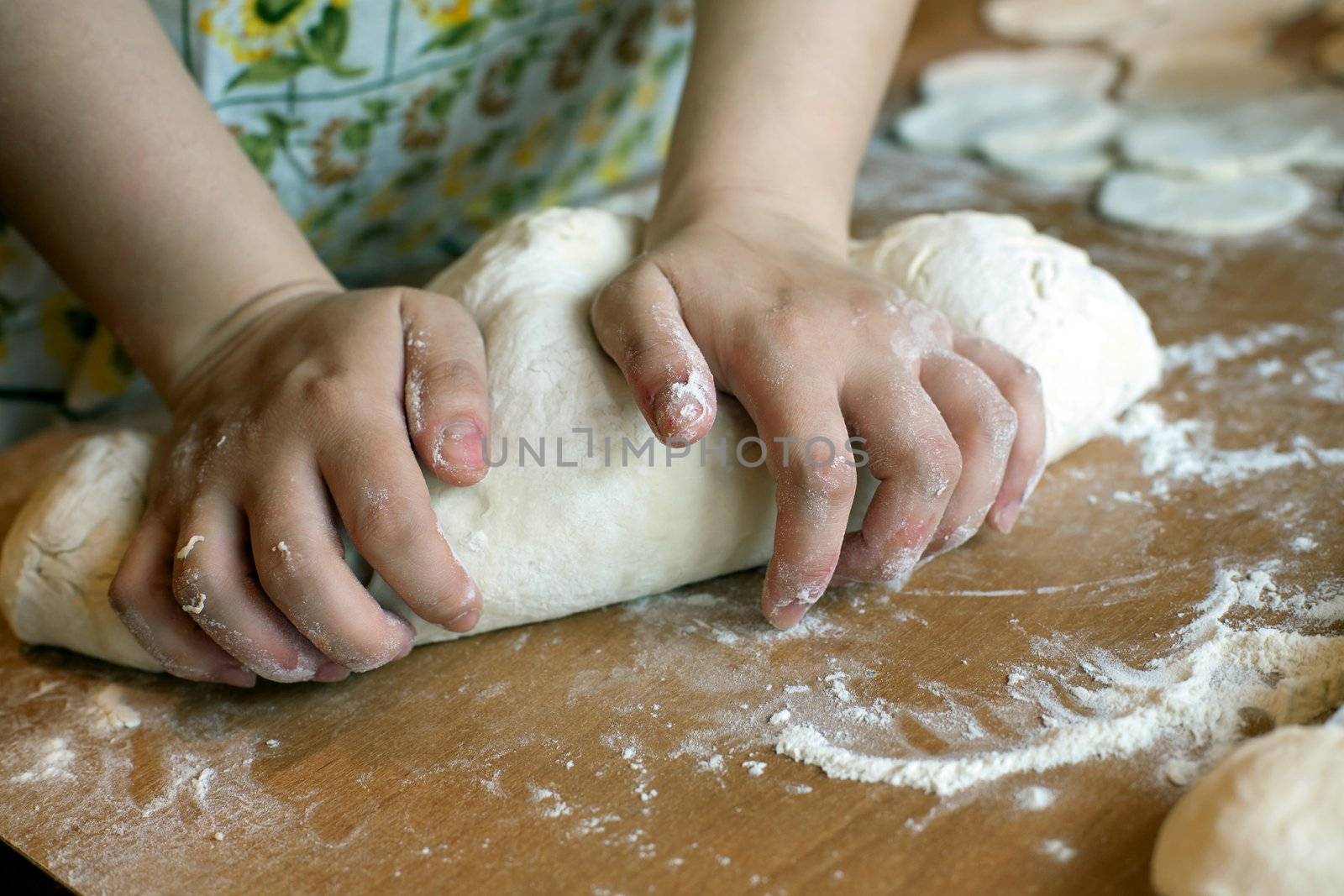 An image of hands making dough for dumplings