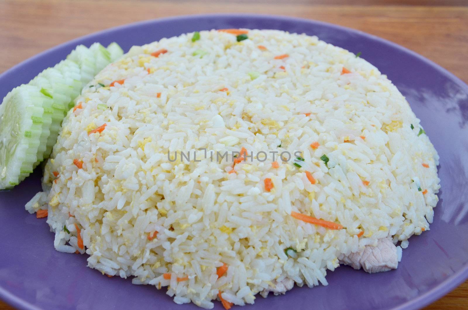 fried rice with pork , served with cucumber