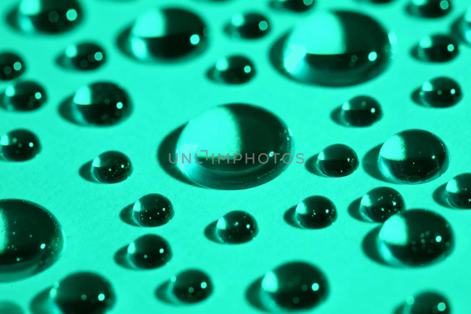 Abstract background with water drops on green glass
