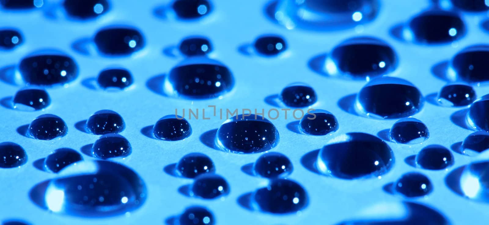 Water drops on blue glass by velkol