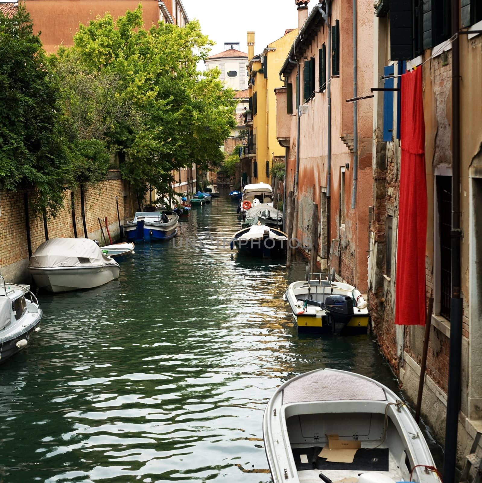 An image of a canal with boat in Venice