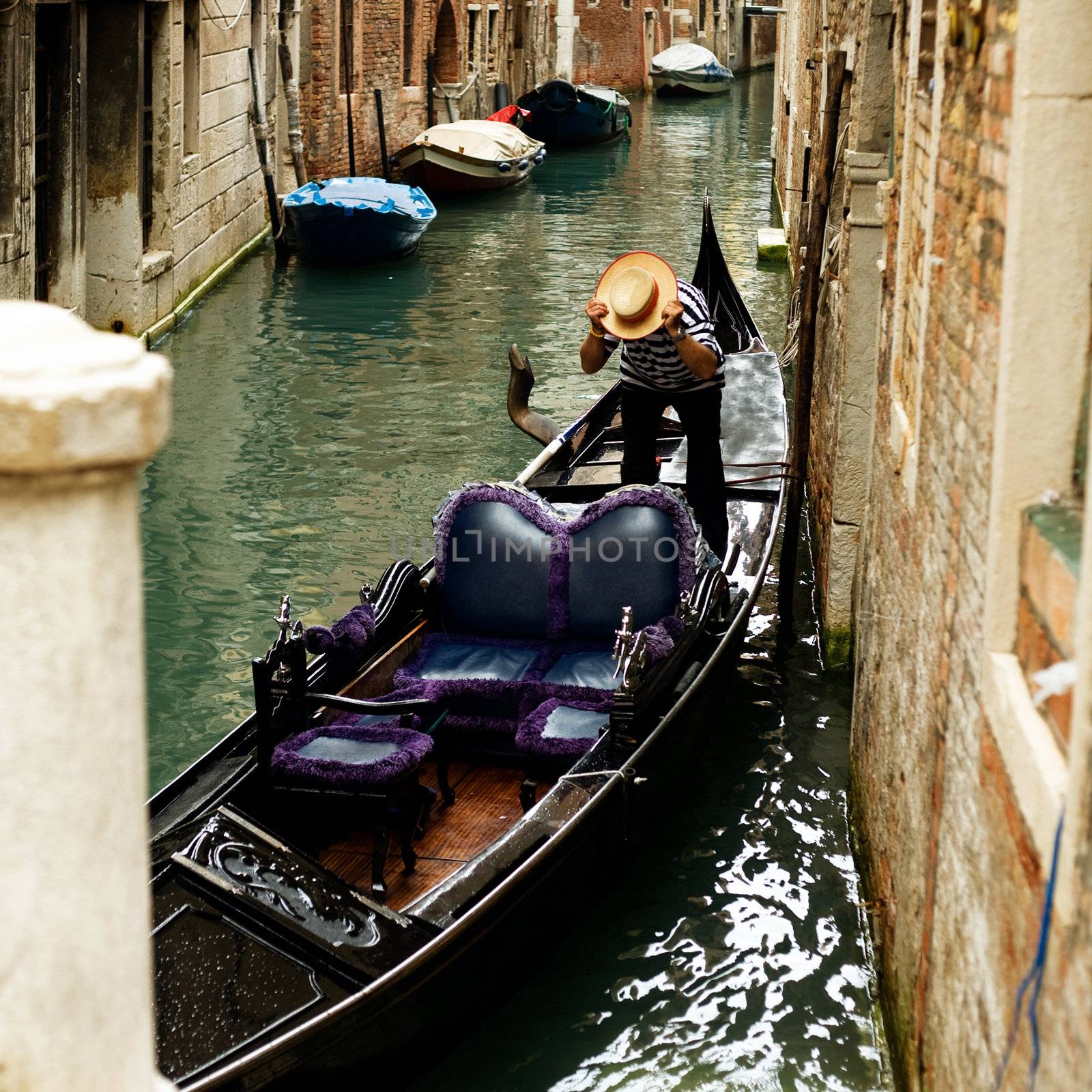 An image of a gondola  in a narrow canal