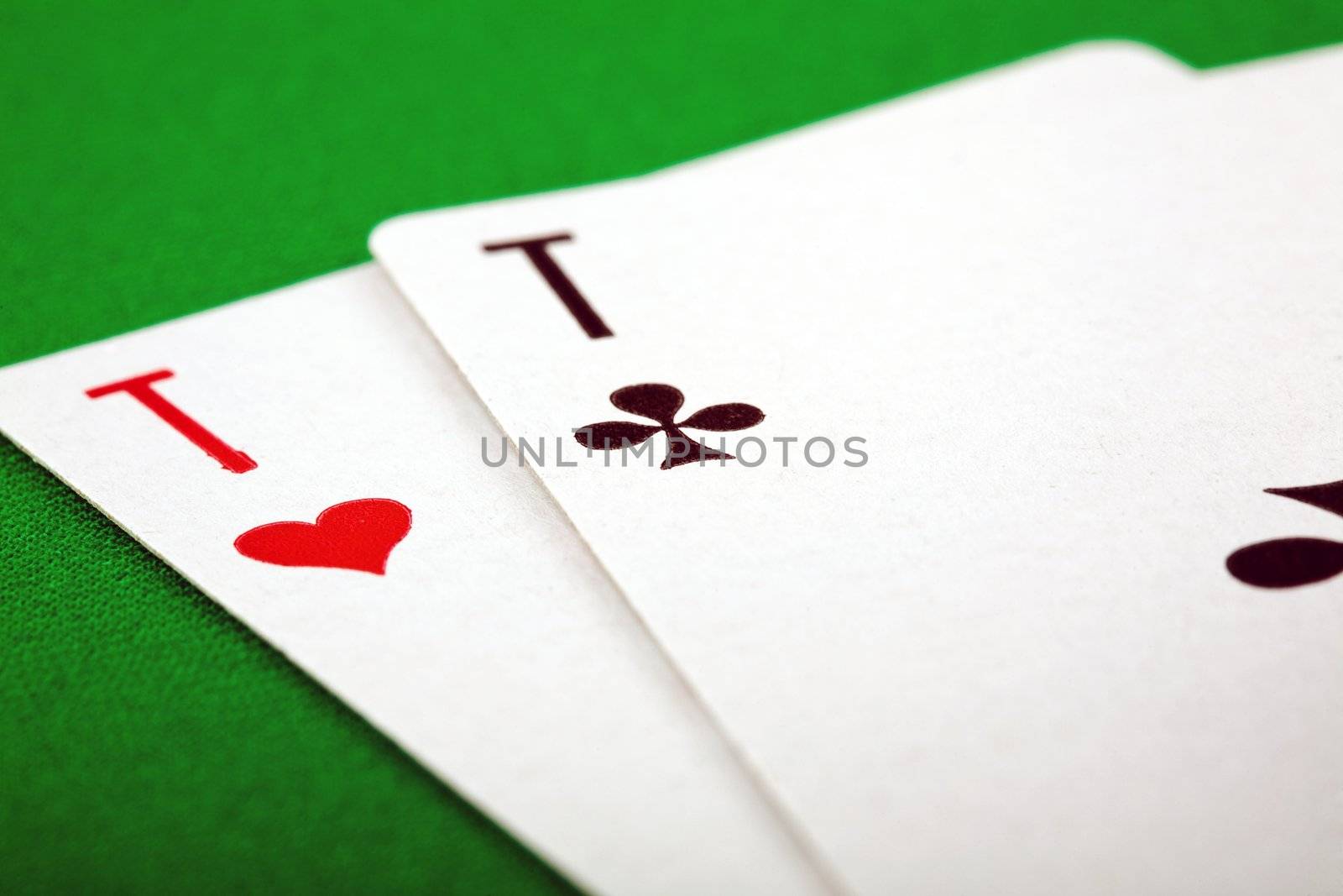 An image of two playing cards on green background
