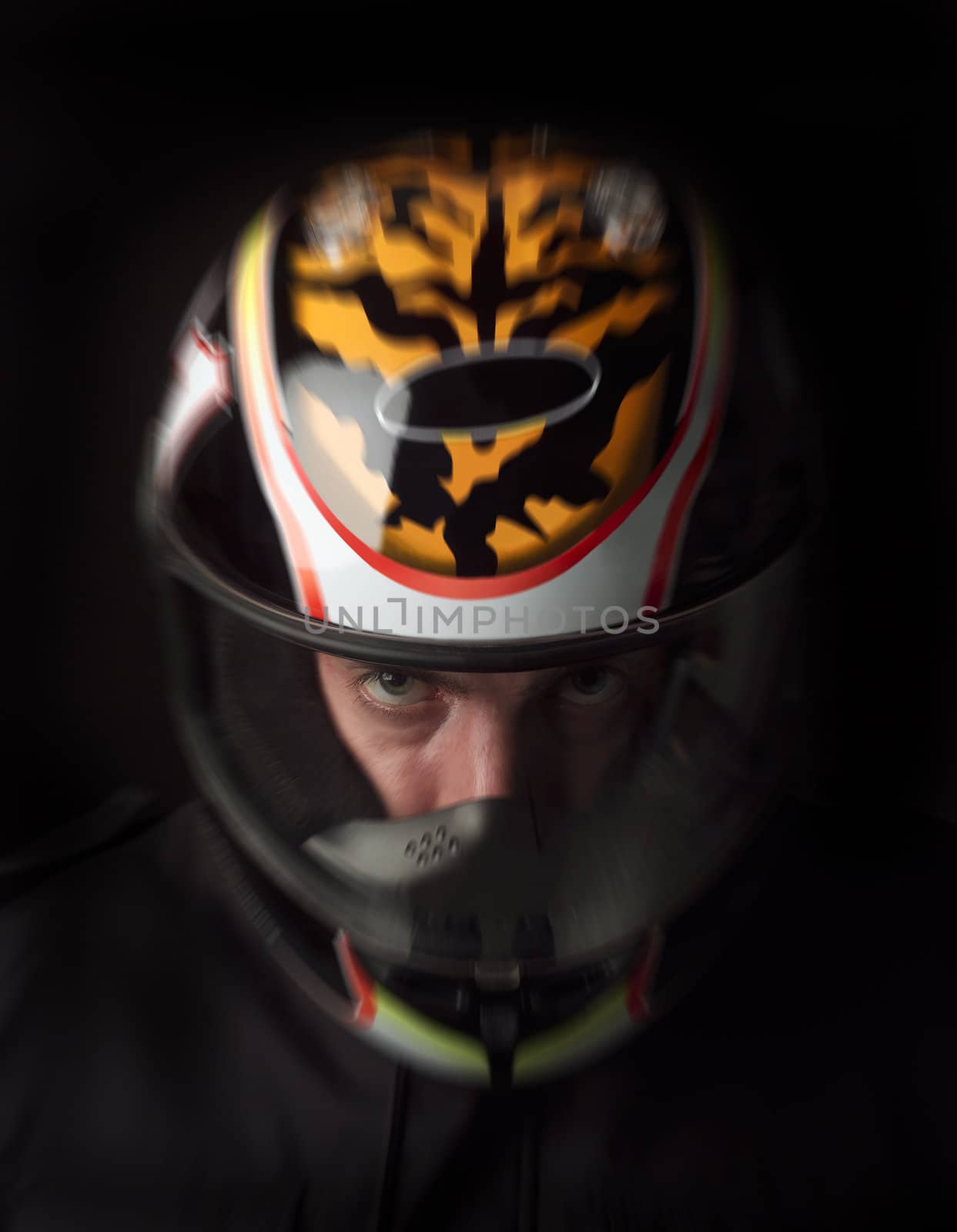 Man with motorcycle helmet on black background